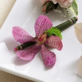 FTD Pink Mokara Boutonierre - The FTDÂ® Pink Mokara Boutonniere brings an exotic sophistication to the   overall look of your groomsmen. A fuchsia Mokara Orchid bloom is   accented with a single green button pom and secured on a equisetum stem   to create a modern take on the traditional boutonniere. Approx. 4âH x   2âW.   