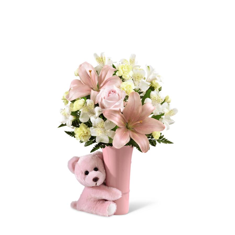 FTD Baby Girl BIg Hug Bouquet - The FTD Baby Girl Hug Bouquet is a sweet and adorable way to   congratulate the new family! Pastel pink roses combine with pale yellow   mini carnations, white Peruvian lilies, pink Asiatic lilies and a   variety of lush greens, all perfectly presented in a blushing pink   ceramic vase hugged by a darling matching pink plush bear to create a   wonderful welcome to the baby girl. GOOD bouquet includes 8 stems.   Approx. 15H x 12W. BETTER bouquet includes 12 stems. Approx. 16â=H x   13âW. BEST bouquet includes 16 stems. Approx. 17H x 15W.   