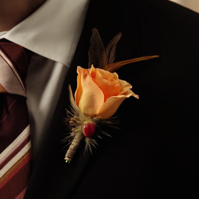 FTD Free Spirit Boutonniere - The FTDÂ® Free Spiritâ¢ Boutonniere adds a beautiful spark of color for   your wedding day. A single orange rose is accented with red hypericum   berries and seeded eucalyptus for a sunlit appeal that will give an   elegant look to your wedding party. Approx. 3âH x 2âW.   