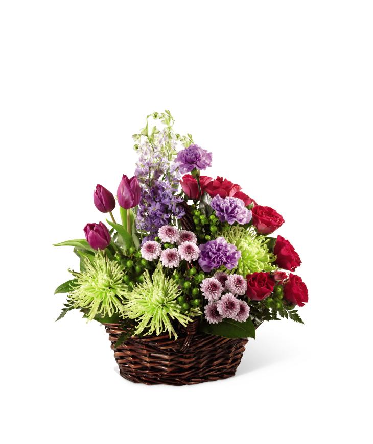 FTD Truly Loved Basket - The FTD Truly Loved Basket exudes fantastic color, warmth and cheer to   convey your most heartfelt sympathies for their loss. Purple tulips,   fuchsia spray roses, lavender carnations, lavender larkspur, lavender   button poms, jade spider chrysanthemums, green hypericum berries and   lush greens are beautifully arranged in a brown willow basket to create a   wonderful way to show how much you care.      18âh x 14âw