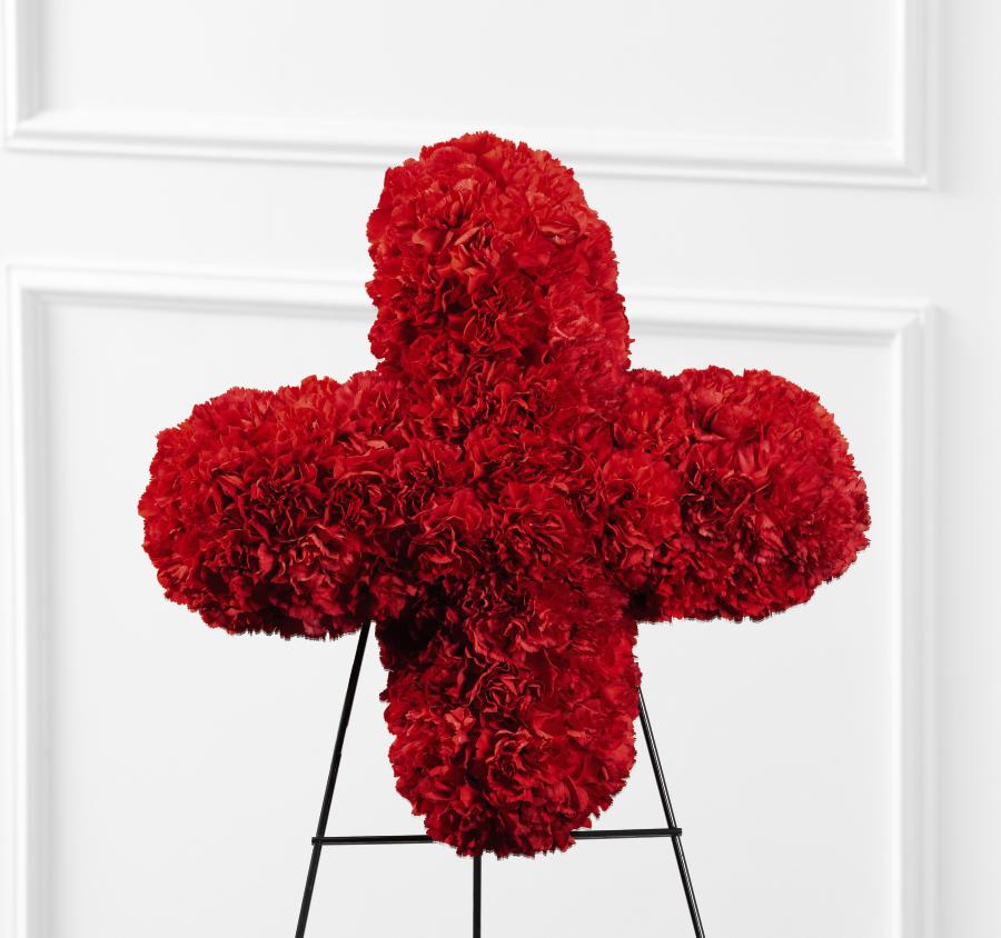 FTD Our Hearts Speak to You Red Cross - The FTD Our Hearts Speak to You Red Cross is a beautiful addition   to their final farewell service. Rich red carnations are brought   together to form the Red Cross symbol, displaying the departed's   devotion to the cause or commemorating how the Red Cross helped them in   their time of need. Displayed on a wire easel.      18""h x 18""w
