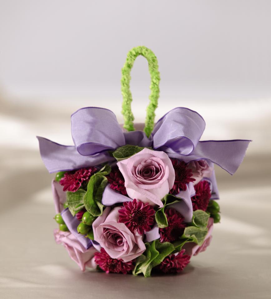 The FTD Enlightened Love Pomander - The FTDÂ® Enlightened Loveâ¢ Pomander is a sweet way to make your way down   the aisle. Lavender roses, purple button pompons, green hypericum   berries and Bells of Ireland are arranged in the shape of a perfect ball   accented with a lavender French taffeta ribbon at the top and intended   to be held from an apple green chenille wire. Approx. 5-inches in   diameter.   5â dia"