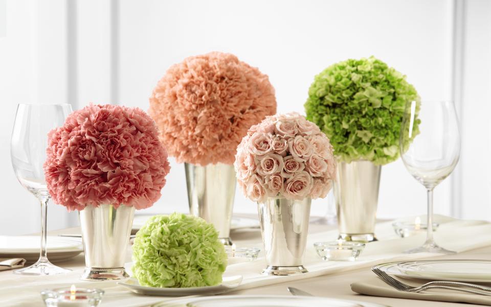 FTD Bridesmaid's Garden Centerpiece - The FTD Bridesmaid's Garden Centerpiece is a lovely way to bring   bright, bold clusters of color to your reception. A collection of   bouquets featuring a single type of flower, including peach carnations,   pink carnations, pink spray roses, pistachio mini carnations, and green   hydrangea are each set in small and medium silver julep cups to create a   memorable display. 5 bouquets in total. Bouquets are approximately 5 to   7-inches in diameter.  