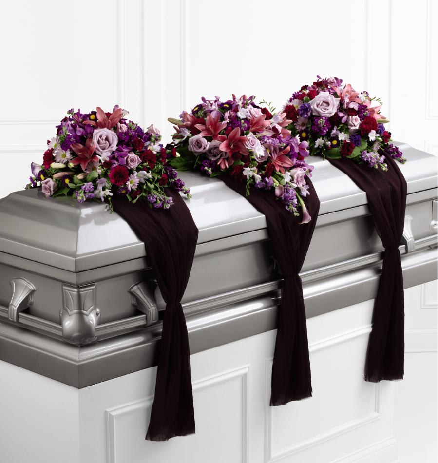 FTD Refreshing Mix Casket Spray - The FTD Refreshing Mix Casket Spray is a set of three   arrangements that flank the top of the casket for an exquisite and   sophisticated look, ideal for a closed casket service. The center   arrangement consists of lavender roses, dark pink Asiatic lilies, pink   mini calla lilies, lavender freesia, purple and lavender stock, fuchsia   carnations and mini carnations, purple mokara orchids, and purple   matsumoto asters. The two end pieces consist of dark pink Asiatic   lilies, purple double lisianthus, purple and lavender stock, lavender   roses, fuchsia carnations, lavender freesia, lavender traditional   daisies and matsumoto asters. All three arrangements are placed on   individual pieces of purple sheer fabric which hang down for an elegant   look.      Centerh x 22w