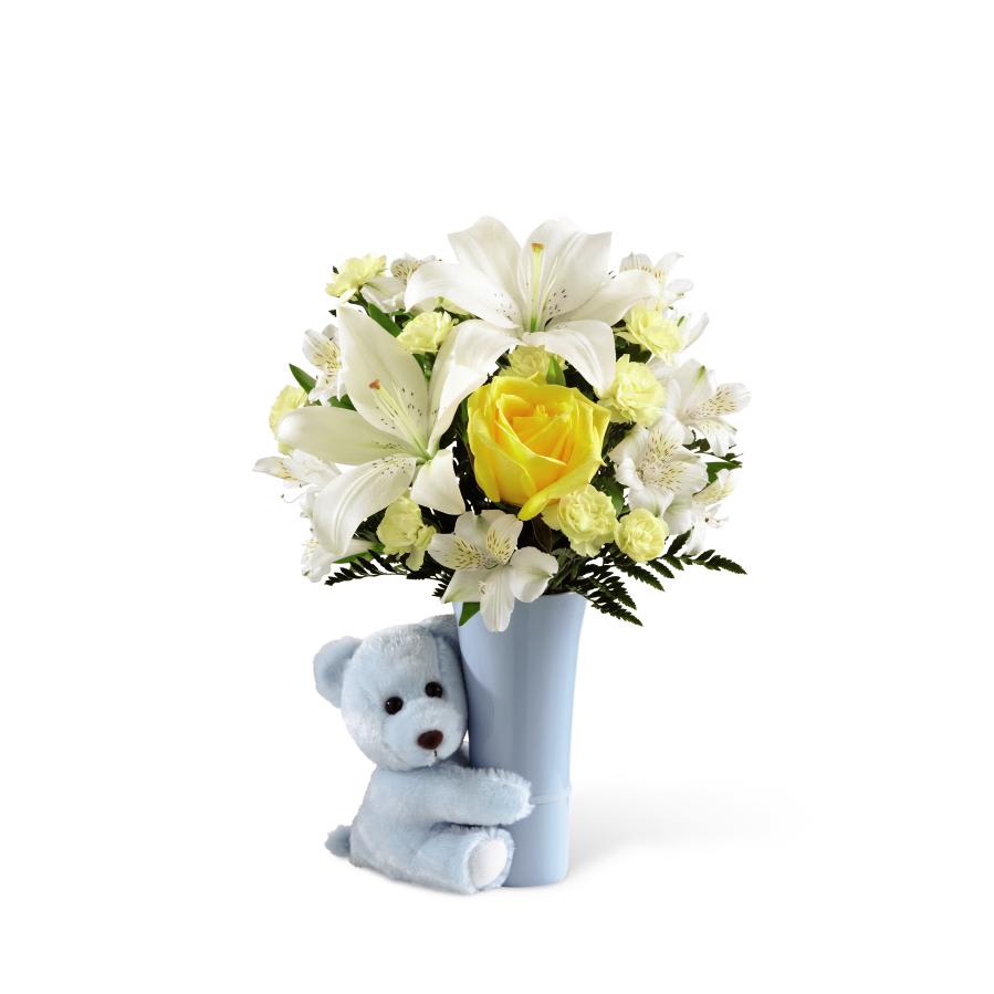 FTD Baby Boy BIg Hug Bouquet - The FTD Baby Boy Hug Bouquet is a sweet and adorable way to   congratulate the new family! Bright and sunny yellow roses combine with   pale yellow mini carnations, white Peruvian lilies, white Asiatic lilies  and a variety of lush greens, all perfectly presented in a light blue   ceramic vase hugged by a darling matching blue plush bear to create a   wonderful welcome to the baby boy. GOOD bouquet includes 8 stems.   Approx. 15H x 11W. BETTER bouquet includes 12 stems. Approx. 16H x   12W. BEST bouquet includes 16 stems. Approx. 17H x 13W.   