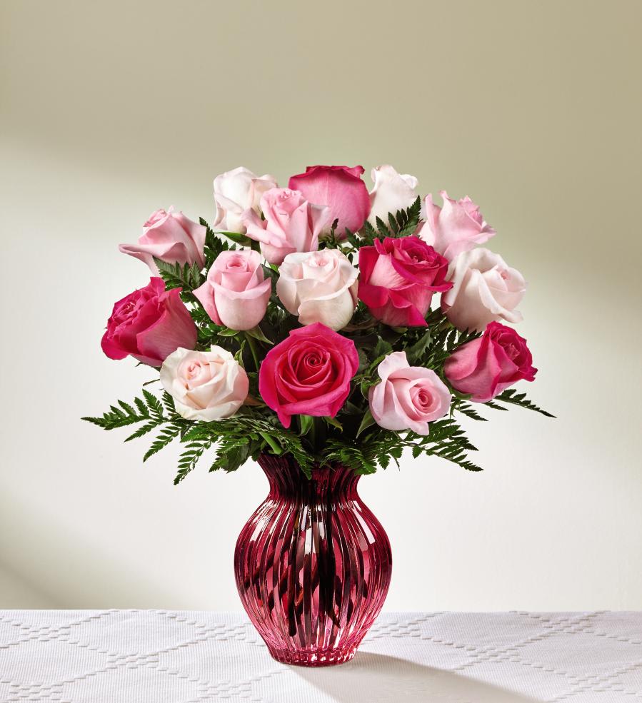 The FTD Happy Spring Mixed Rose Bouquet - Deluxe - Perfectly pink in every way this stunning rose bouquet will have them blushing with pure happiness and absolute delight! An assortment of pink roses, from the palest pink to the brightest fuchsia hue, are arranged with an eye for color and drama within a blushing keepsake berry pink glass vase. A message of love and gratitude from your heart to theirs, this rose bouquet is set to create an excellent Mother's Day, thank you, or thinking of you gift! GOOD bouquet includes 12 stems. Approx. 14"H x 12"W. BETTER bouquet includes 15 stems. Approx. 15"H x 13"W. BEST bouquet includes 18 stems. Approx. 16"H x 14"W.