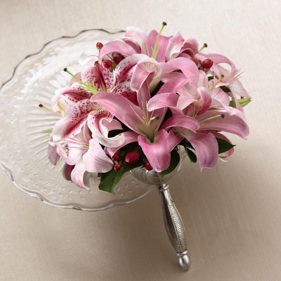 FTD Sparkle Pink Bouque - The FTDÂ® Sparkle Pinkâ¢ Bouquet is a fresh burst of color to add to the   magic and romance of the wedding day. Pink Oriental Lilies and Asiatic   Lilies are brought together with eye-catching Stargazer lilies, all   beautifully accented with red hypericum berries and lush greens.   Presented in a silver metallic bouquet holder to give it a finishing   touch, this bouquet is a delightful display of fragrant floral elegance.   Approx. 12âH x 11âW. 