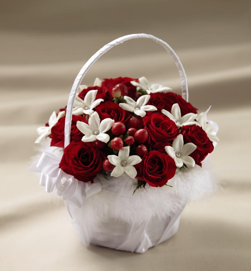 FTD Baby Love Flower Girl Basket - The FTD Baby Love Flower Girl Basket is a sweet and charming   arrangement that your flower girl will love. Red spray roses,   stephanotis blooms, and red hypericum berries are arranged in a handled   basket covered with white satin ribbon and accented with white feathers   around the rim, to give it an appealing and feminine look that will   sweetly escort her down the aisle. Approx. 10âH x 7âW. 