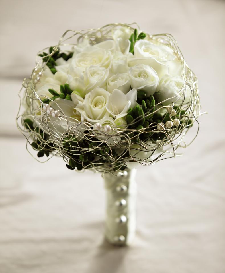 FTD Evermore Bouquet - The FTDÂ® Evermoreâ¢ Bouquet is a romantic display of modern   sophistication. White roses, spray roses, freesia, and hydrangea are   accented with green hypericum berries and presented in an elegant gold   wire bouquet collar displaying ivory pearls. With the stems wrapped in   an ivory satin ribbon accented with domed silver buttons, this bouquet   is the perfect companion for your walk down the aisle. Approx. 9-inches   in diameter. 