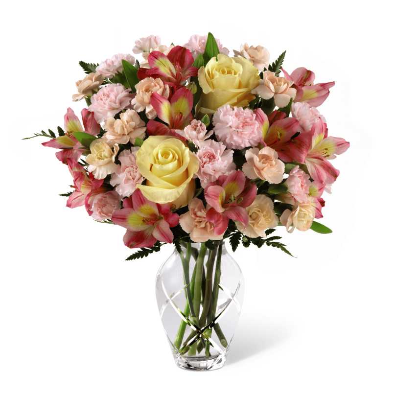 The FTD Spring Garden Bouquet - The FTD Spring Garden Bouquet blooms in soft and lovely seasonal color to make a glorious Motherâs Day treat that will thrill mom on her big day. Soft yellow roses, pink spray roses and mini carnations and bright pink Peruvian Lilies are accented with lush greens to create a refreshing flower arrangement in a heavy, crystal clear glass vase sparkling with a contemporary cut glass design. Why limit this bouquet to Motherâs Day? Itâs also perfect for birthdays, special anniversaries or to say âthank you!â