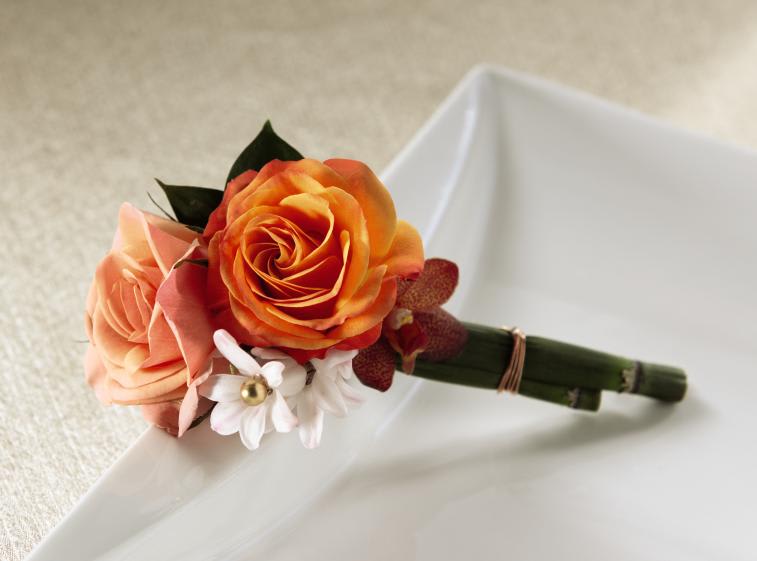 FTD Sunset Dream Boutonniere - The FTDÂ® Sunset Dreamâ¢ Boutonniere blazes with color and vibrant energy.   Peach spray rose, orange spray rose, pink hyacinth and red mokara   orchids are perfectly arranged secured to an equisetum stem for stunning   overall look. Approx. 5âH x 2âW.   