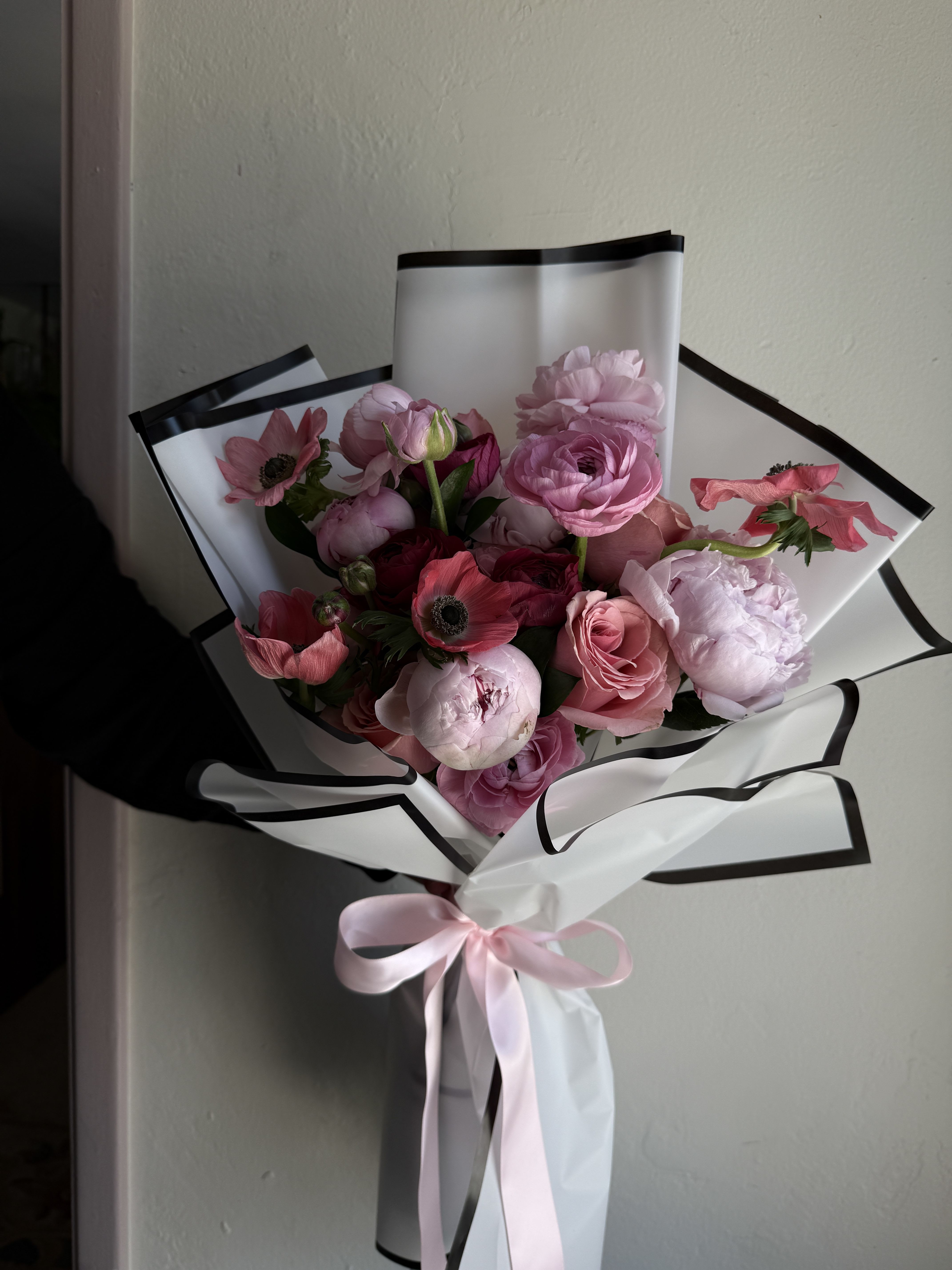 Peonies &amp; Co. Garden Bouquet - A garden-inspired bouquet featuring lush peonies, ranunculus, roses and anemones, arranged to highlight their natural texture and charm. With its airy, organic feel and rich layers of petals, this bouquet brings a fresh, effortless beauty to any setting.