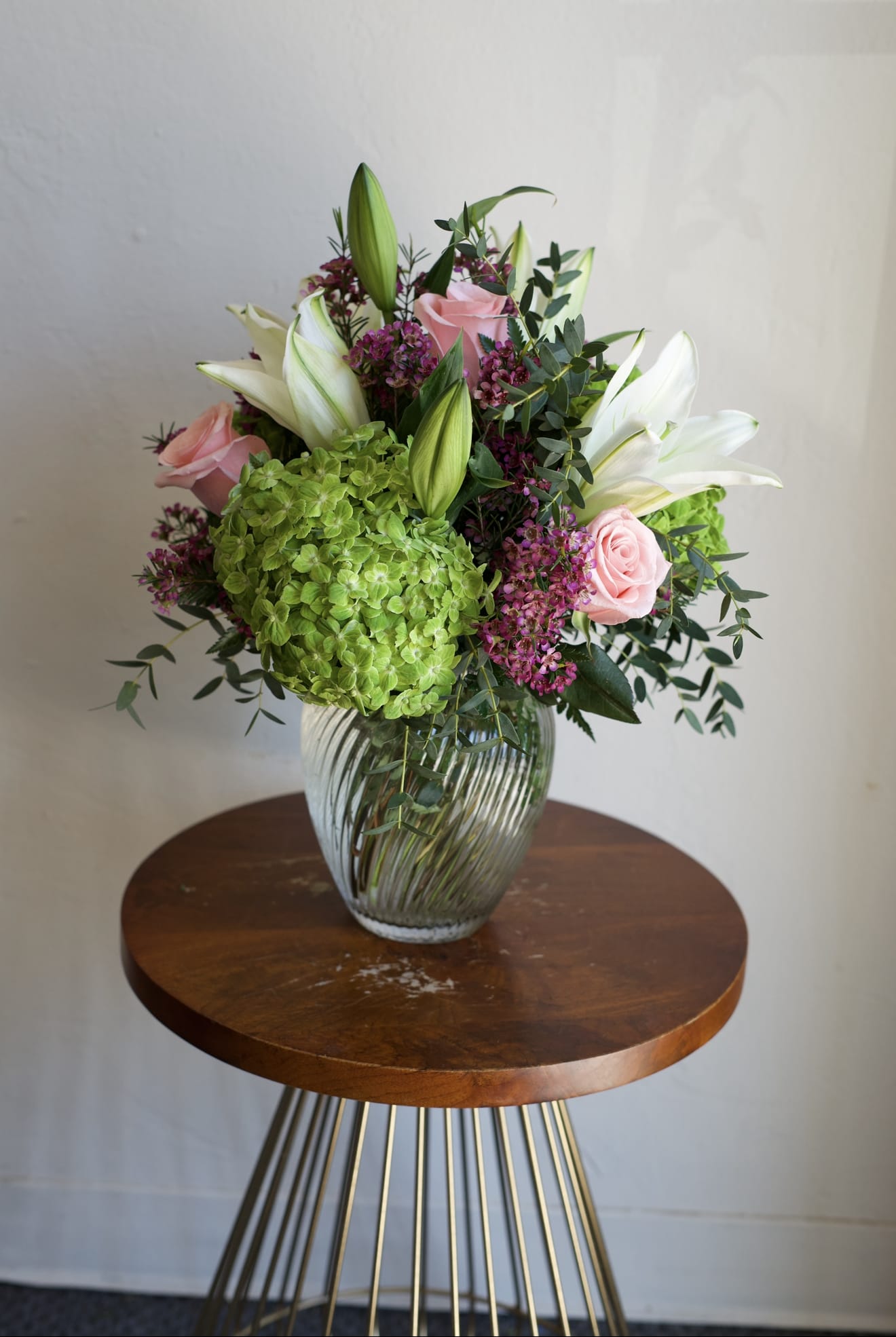Hydrangeas &amp; Roses - A fresh and elegant arrangement featuring lush green hydrangeas, classic roses, and graceful lilies. This design blends soft texture with refined structure, pairing the fullness of hydrangeas with the timeless beauty of roses and the delicate fragrance of lilies. The result is a vibrant yet sophisticated bouquet that feels both modern and naturally beautiful—perfect for celebrating with a thoughtful, garden-inspired touch.