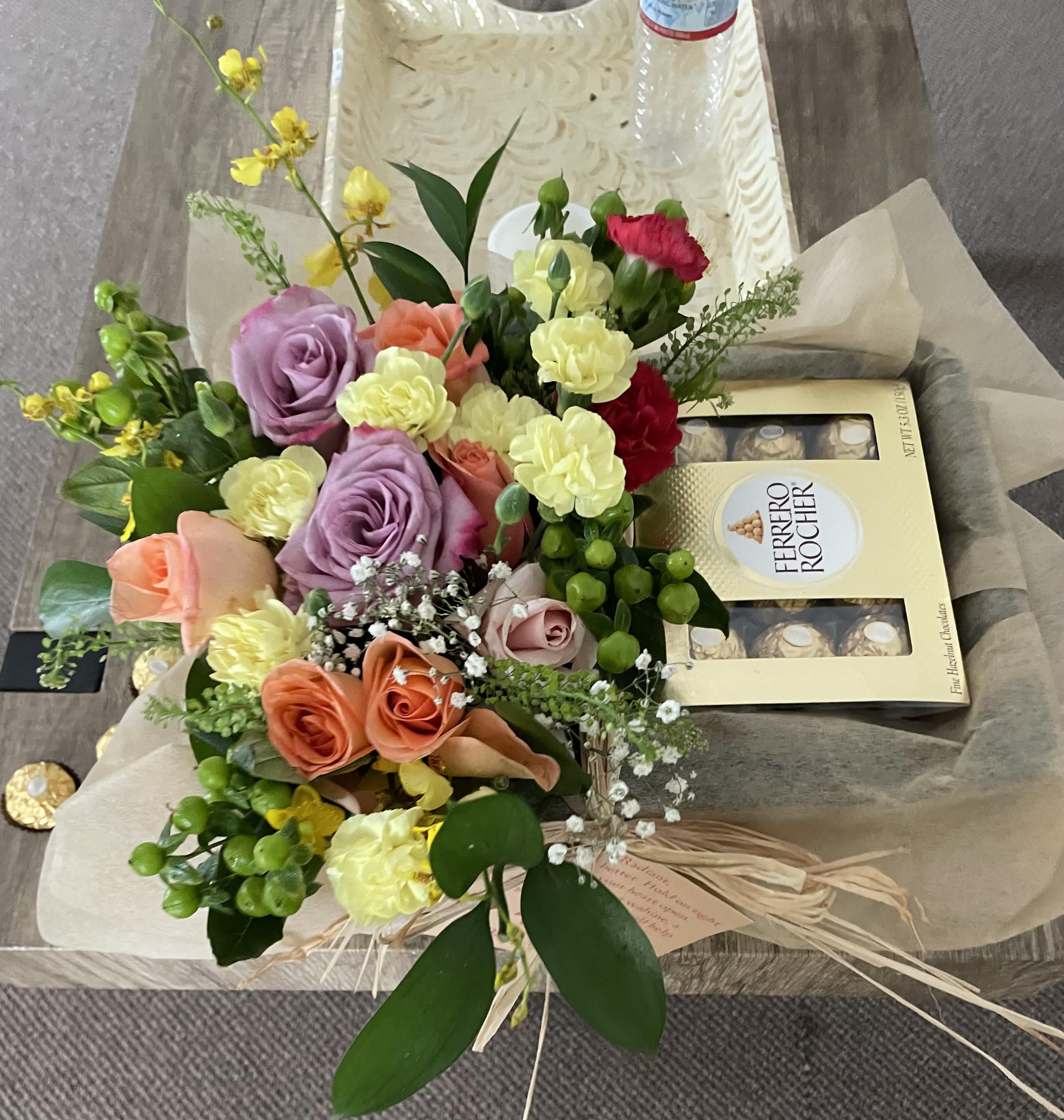 Mixed bouquet of roses and carnations with a Ferrero Rocher box