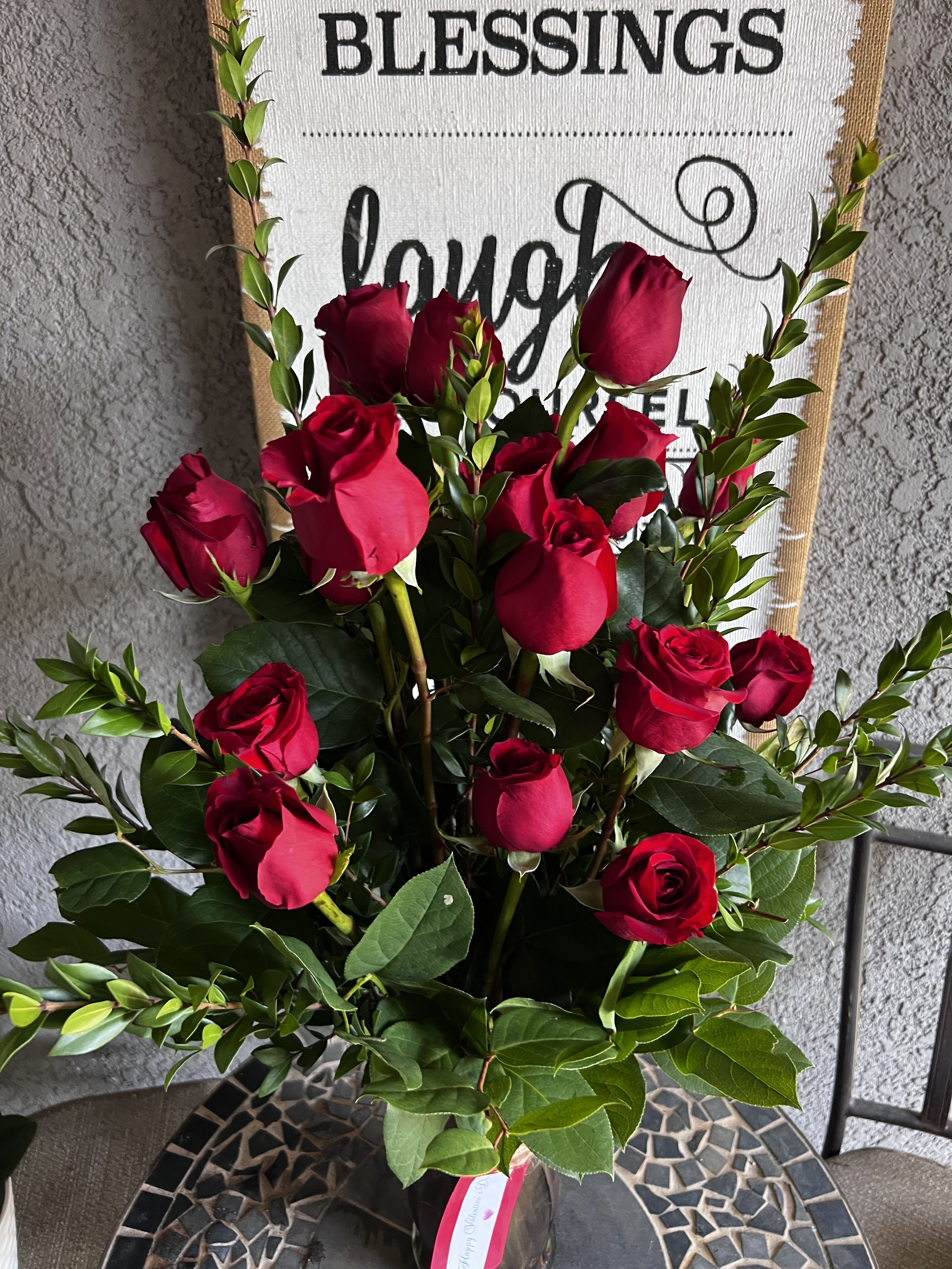 Dozen Long Stemmed Roses with Baby's Breath by BloomNation™ - These dozen red roses with beautiful green foliage .  APPROXIMATE DIMENSIONS: 25" H X 18" 