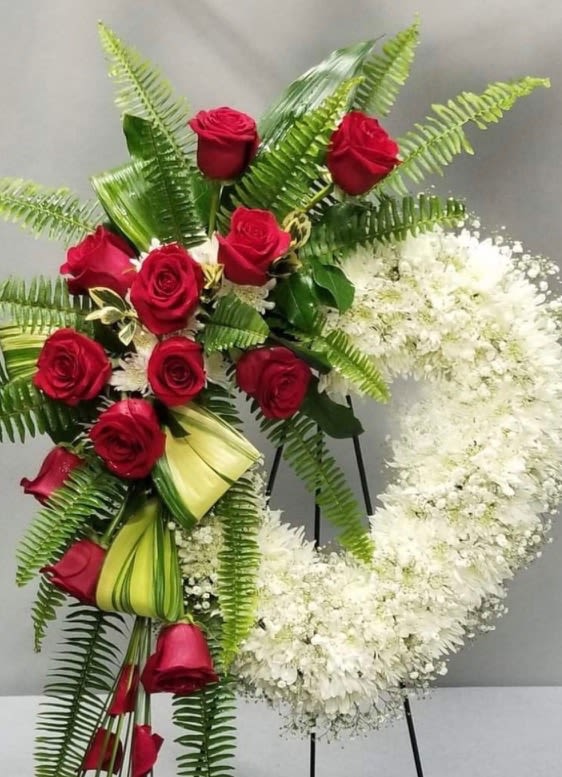 Red roses and white flowers arranged on standing easels