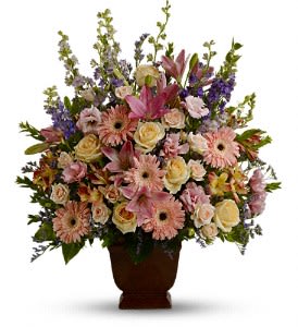 Large mixed bouquet in a brown urn vase with pink and cream flowers