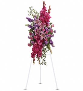 Tall standing floral spray with pink and purple flowers on an easel