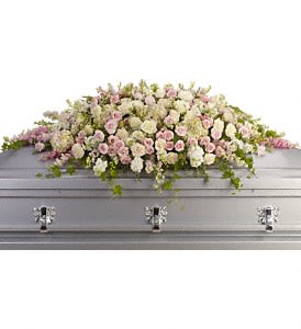 Pastel floral spray on a silver casket