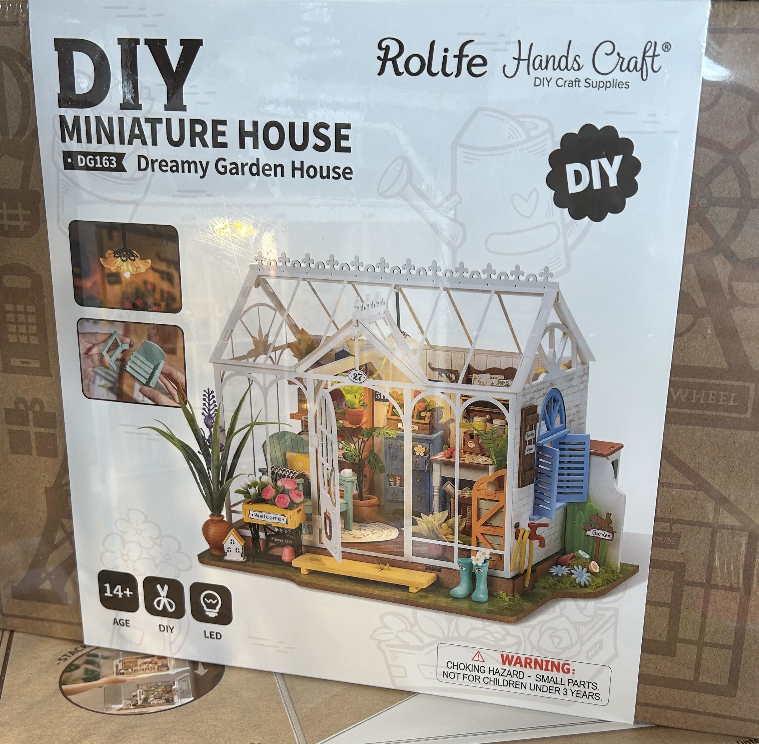 Box for a DIY miniature greenhouse house kit with a garden scene