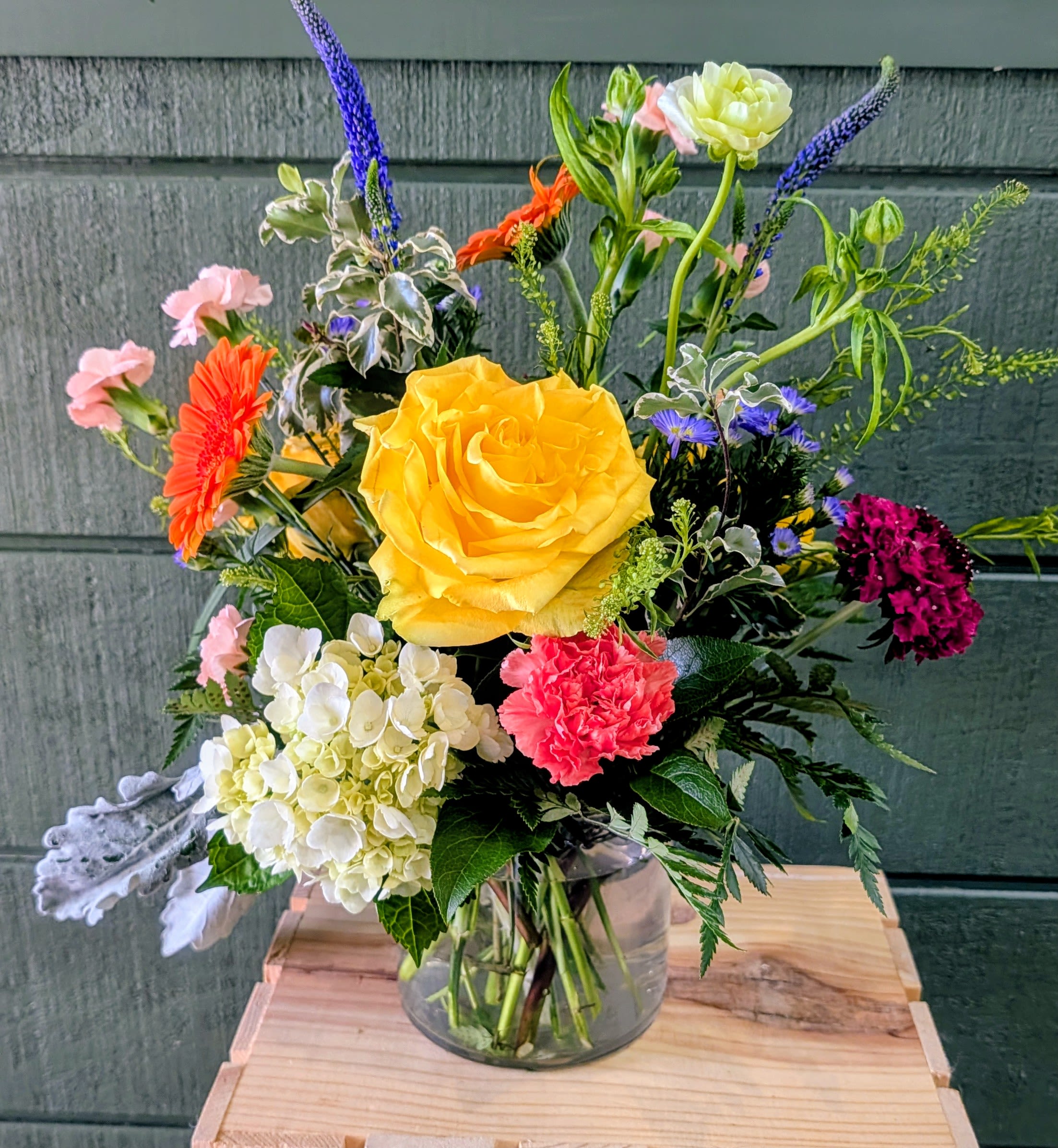 Spring Sensation - Glass container includes hydrangea, roses, veronica, gerbera daisies, mini carnations, dusty miller, aster &amp; greens