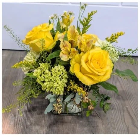 A Little Yellow - Large yellow roses take center stage in this sunny everyday arrangement, paired with yellow-and-cream alstroemeria and white-accented filler blooms for a cheerful birthday bouquet or bright thank-you gift. The compact, low garden-style design fee
