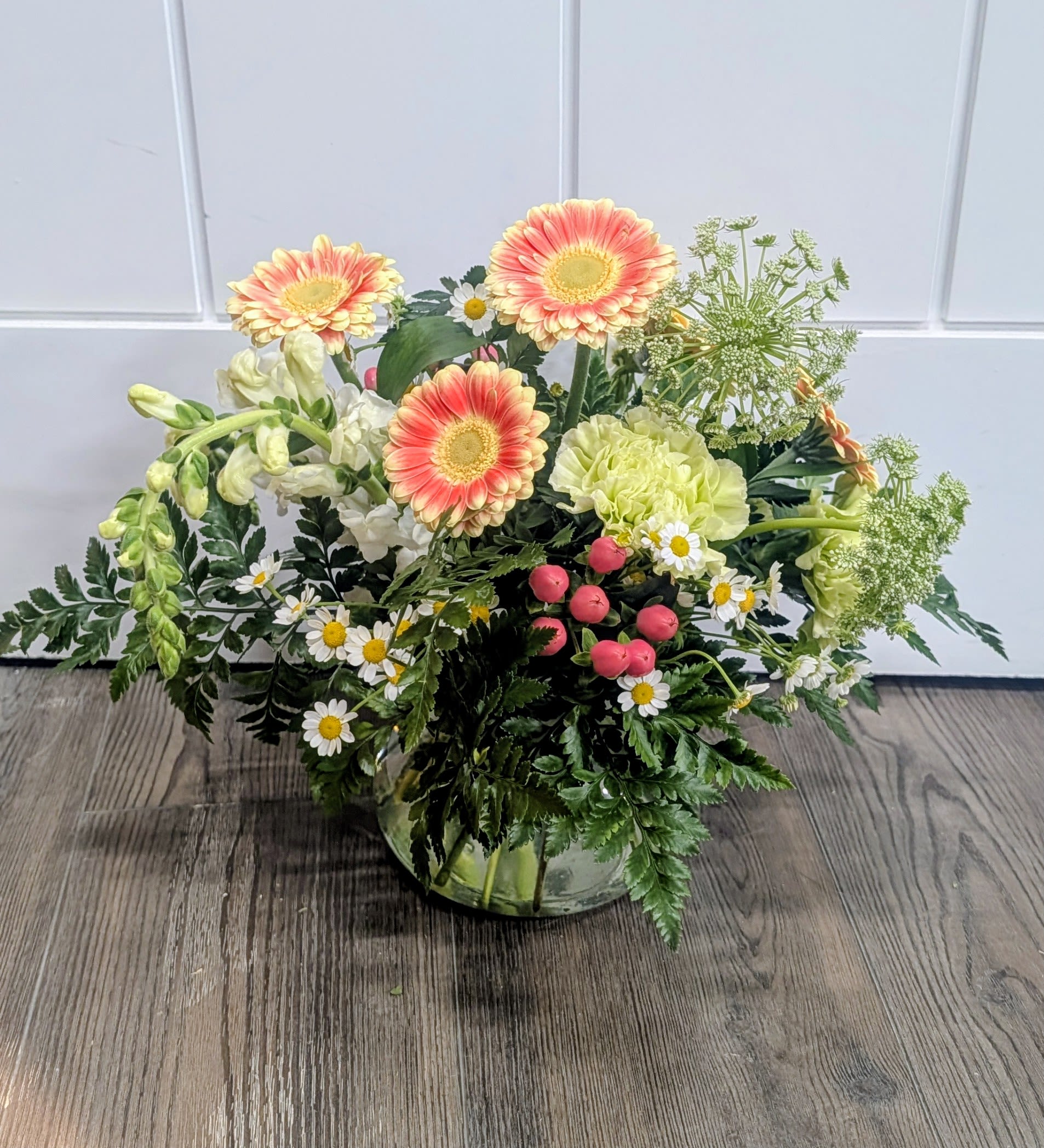 Bloom Into Happiness - Glass container includes gerber daisies, carnations, snapdragons, hypericum berry, queen anne's lace &amp; greens