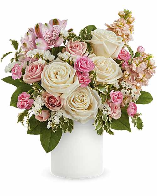 Pink and white rose bouquet in a white vase