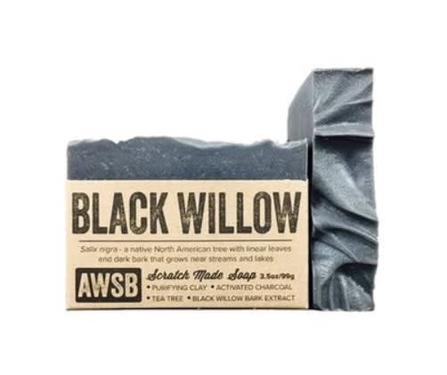 Dark charcoal bar soap with textured top and kraft paper label reading Black Willow.