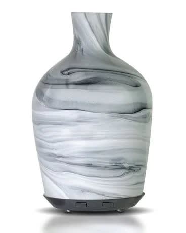 Marble-patterned glass essential oil diffuser with a narrow neck and dark base