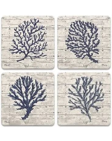 Set of four square coasters with navy coral designs on a whitewashed background
