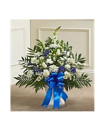 White and blue floral standing spray with a blue ribbon