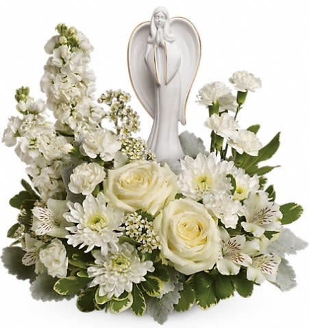 White floral arrangement with angel figurine centerpiece