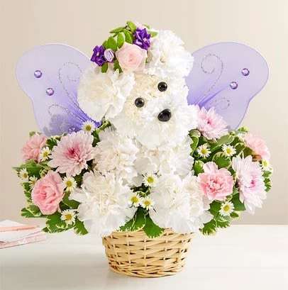 Teddy bear floral arrangement in a basket with purple wings