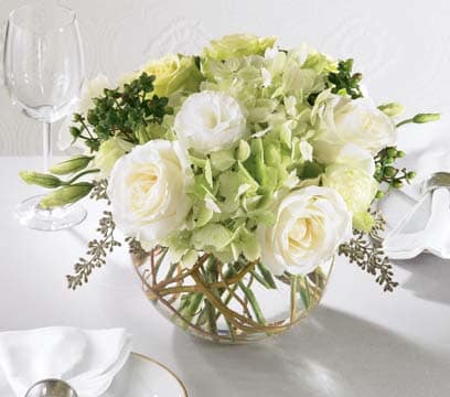 White and pale green floral centerpiece in a glass bowl vase