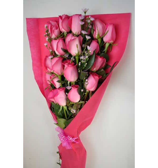 Bouquet of pink roses wrapped in bright pink paper