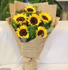 Bouquet of yellow sunflowers wrapped in brown paper