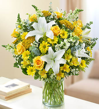 Yellow and White BOUQUET -  Product ID: 95416    roses, lilies, snapdragons, yarrow, alstroemeria and more in bright and beautiful yellow and white, Lush yellow and white arrangement of roses, lilies, snapdragons, yarrow, alstroemeria, daisy poms, solidago and monte casino, accented with variegated pittosporum, spiral eucalyptus and salal Hand-designed by our select florists in a classic glass cylinder vase; vase measures 8"H approximately 24"H x 22"L Medium arrangement measures approximately 22"H x 20"L Small arrangement measures approximately 20"H x 18"L 