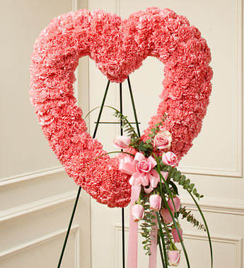 Pink Open Heart - Product ID: 91240   When you need a beautiful way to convey your sympathy and love, this open heart standing spray is the perfect choice. Crafted of soft pink roses and carnations, accented by bear grass Sent directly to the funeral home by family and friends Our florists use only the freshest flowers available so colors and assortment may vary Measures approximately 26"H x 26"W without easel
