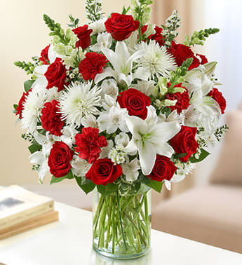 Red and White BOUQUET - Product ID: 95404   Roses, lilies, snapdragons, spider mums, carnations and alstroemeria beautifully arranged by our expert florists. Lush red and white arrangement of roses, lilies, snapdragons, spider mums, carnations, alstroemeria and monte casino, accented with variegated pittosporum, salal, seeded eucalyptus and myrtle Hand-designed by our select florists in a classic glass cylinder vase; vase measures 8"H arrangement measures approximately 24"H x 22"L Medium arrangement measures approximately 22"H x 20"L Small arrangement measures approximately 20"H x 18"L Our florists hand-design each arrangement