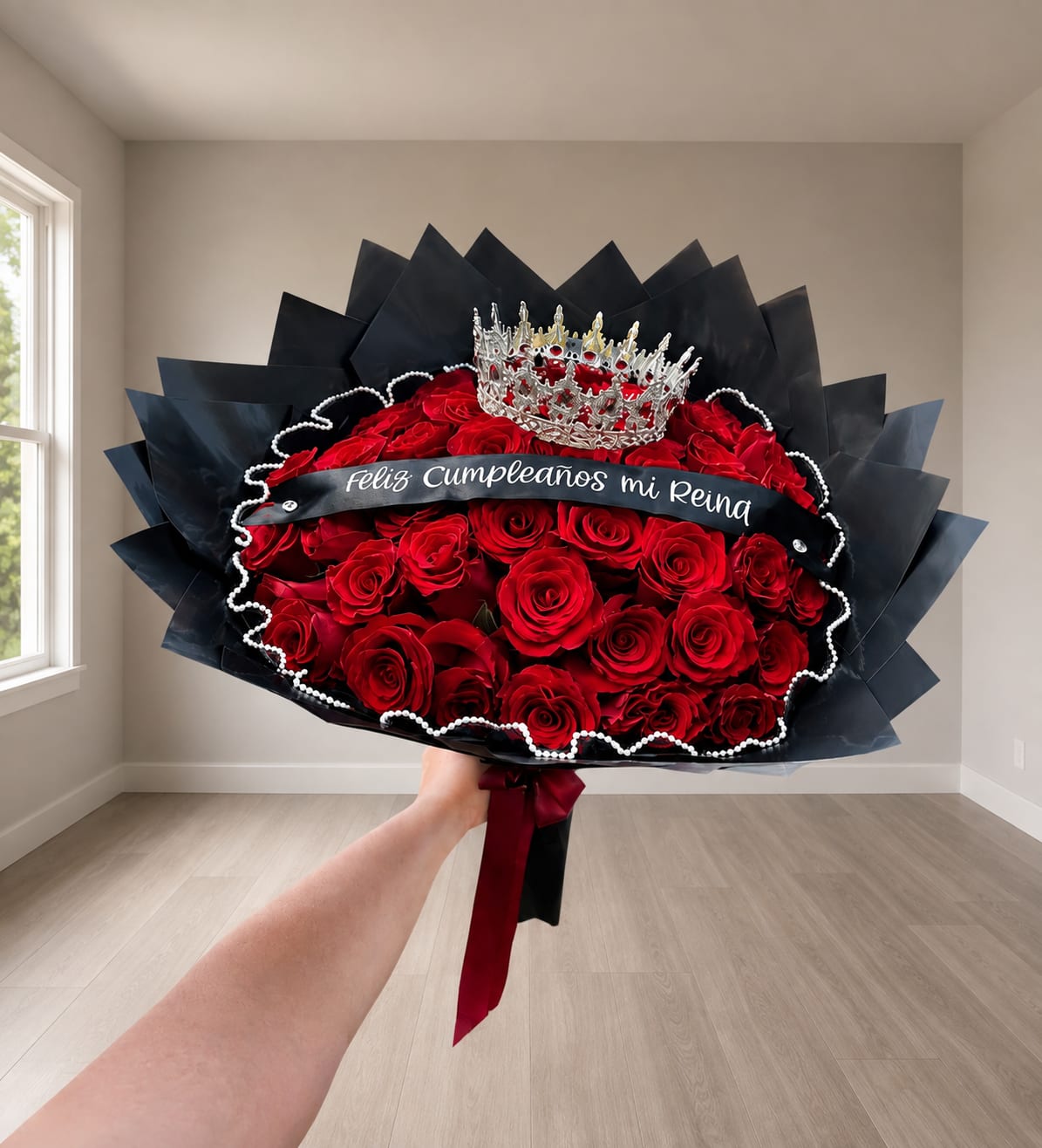 Large bouquet of red roses with a crown and black wrap