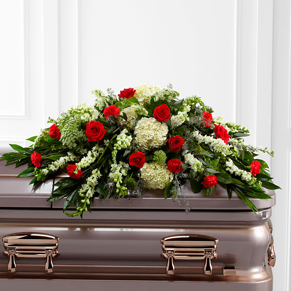 Sincerity Casket Spray - Rich red roses and carnations are eye-catching and elegant in an arrangement of white hydrangea, larkspur, snapdragons, Queen Anne's Lace and assorted lush greens to create a lovely display meant to bedeck the top of their casket bringing comfort and peace to those grieving the loss of the departed.