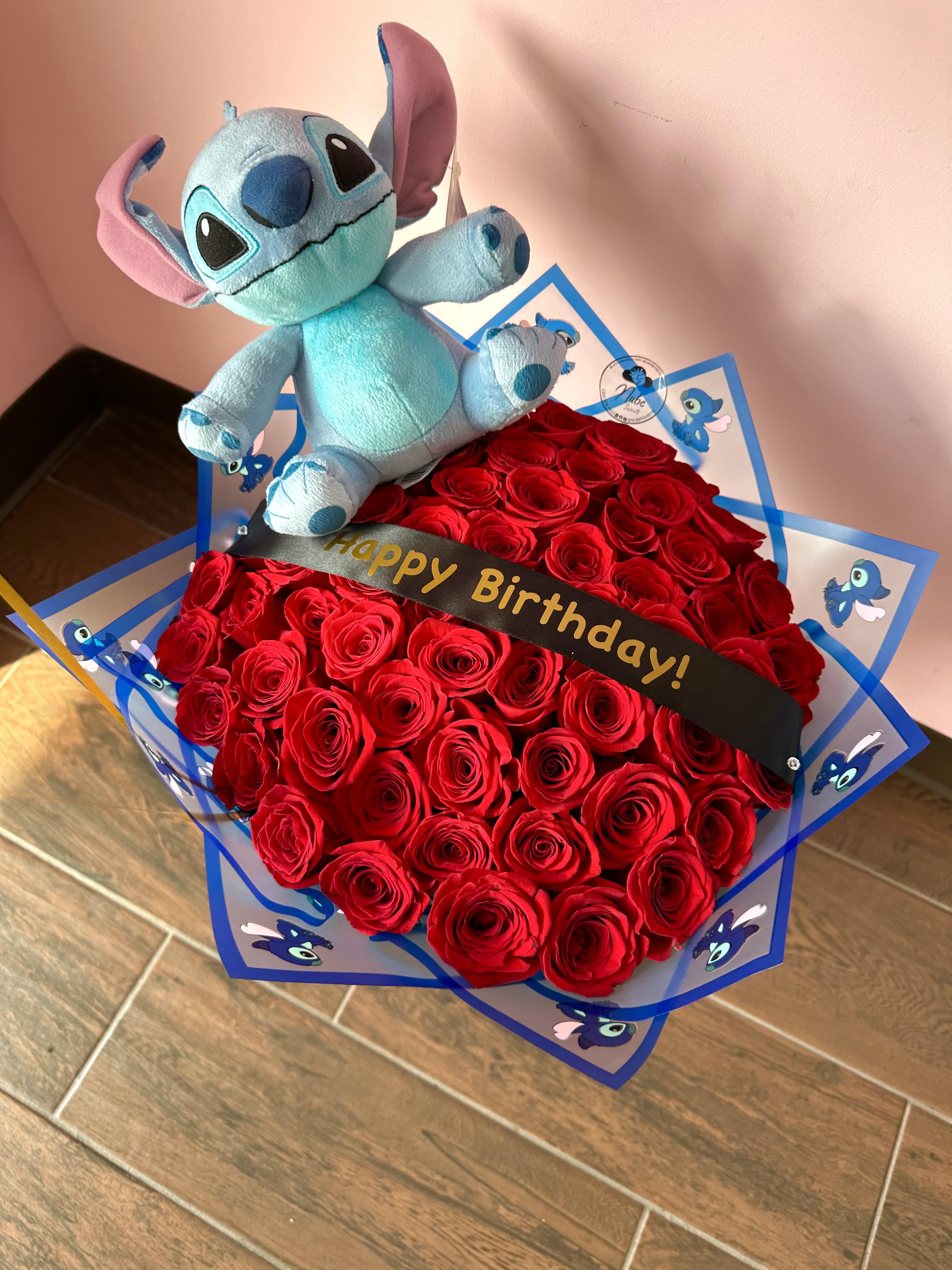Red rose bouquet with a Stitch plush and birthday ribbon