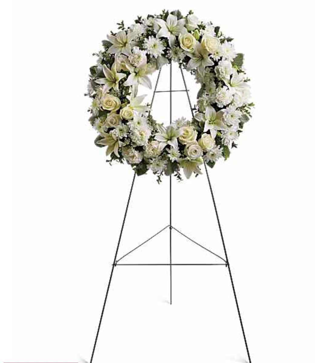 White floral funeral wreath on a standing easel