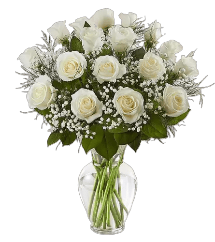White roses and calla lilies in a clear glass vase