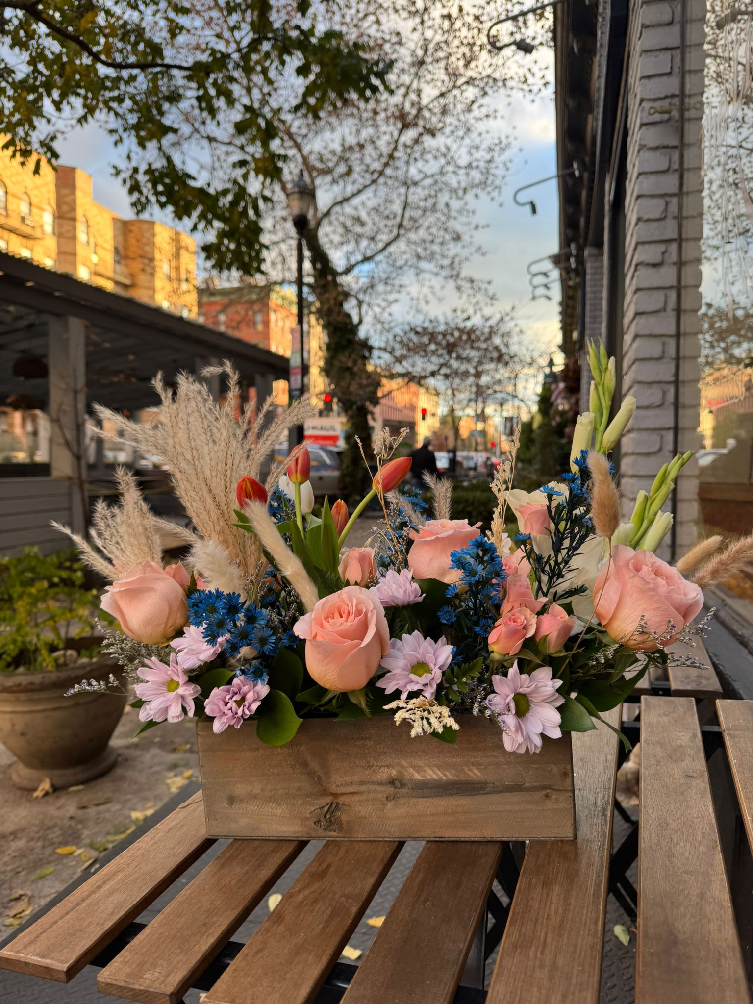 Wild and Free  - A gift for your free-spirited, boho friend (crystals optional).  This trendy arrangement is a mix of dried and fresh materials like bright pops of tulip and a sun palm. The perfect good vibes gift.  Approximate Dimensions: 22"D x 15"H