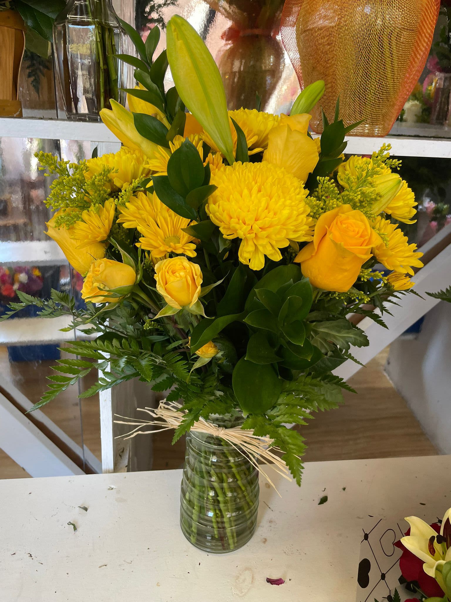 Yellow bouquet of roses and chrysanthemums in a glass vase