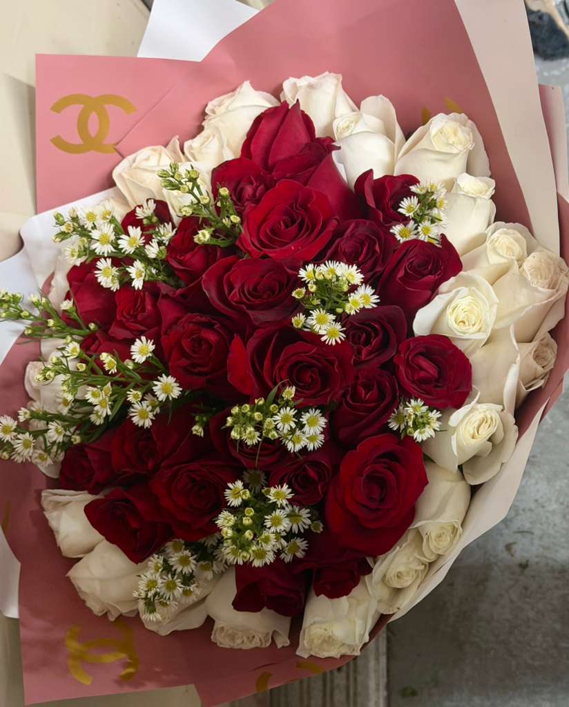 Bouquet of red and white roses with small white filler flowers