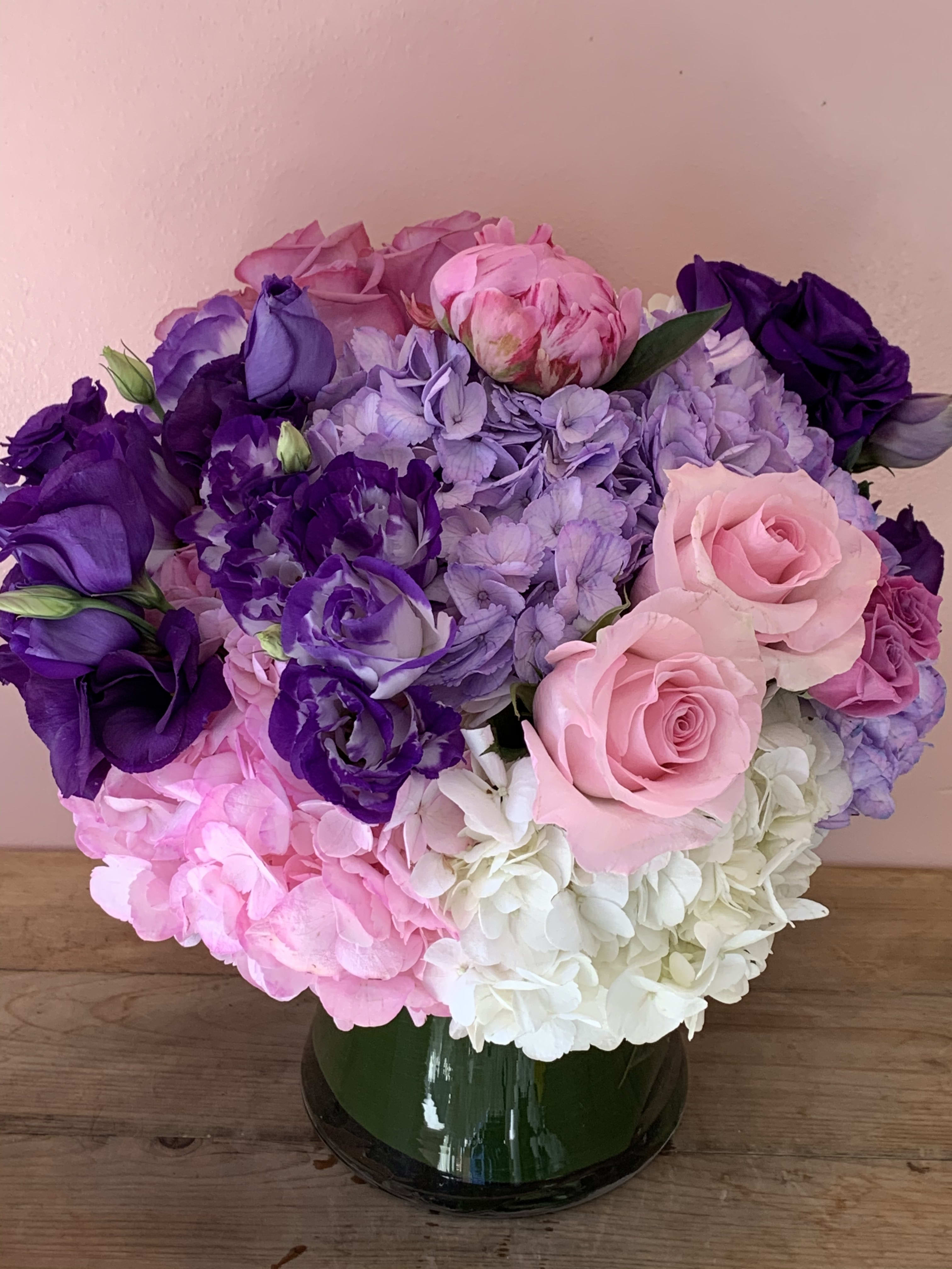 Pink, purple, and white flower bouquet in a glass vase