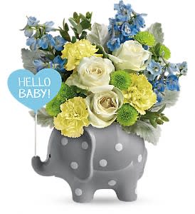 Blue and yellow flower arrangement in a gray elephant planter with a "Hello Baby!" sign